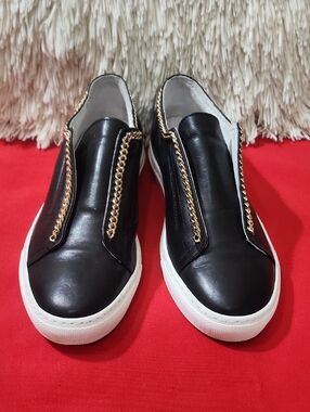 Andre Assous Stella Black Slip-On Sneakers with Gold Chain Trim